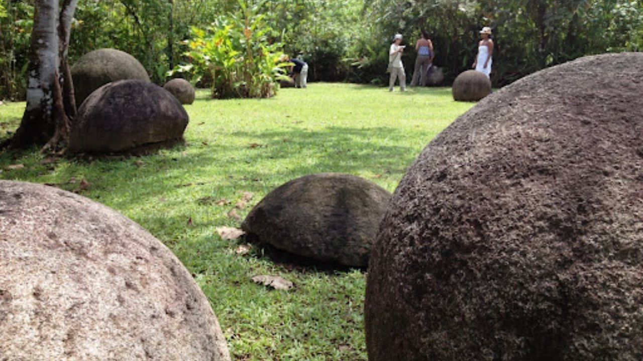Ancient Costa Rica stone spheres in forest clearing.