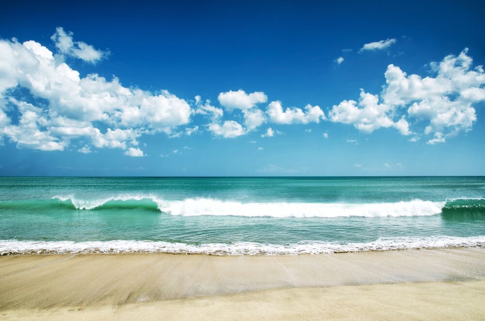 Turquoise waves rolling onto sandy Guanacaste beach in Costa Rica.