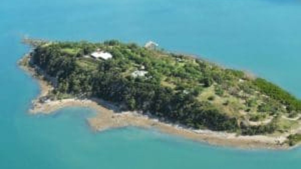Lush island off Nicoya Peninsula surrounded by turquoise water.